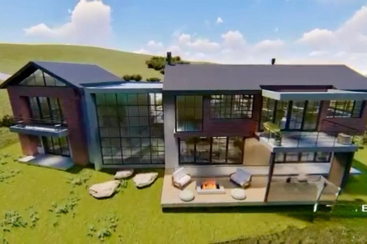 An aerial view of a modern residential property design featuring large glass windows, a balcony, and a patio area with a built-in fire pit.