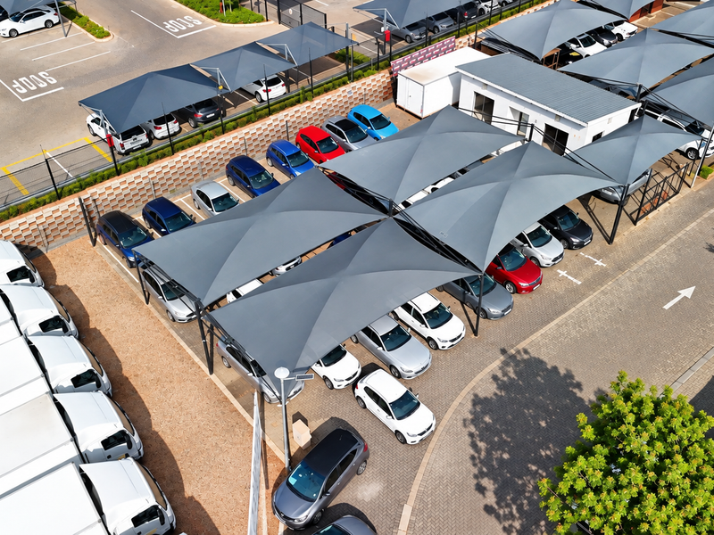 Aerial view of a commercial office parking facility featuring multiple shade cloth carports and paved parking bays.