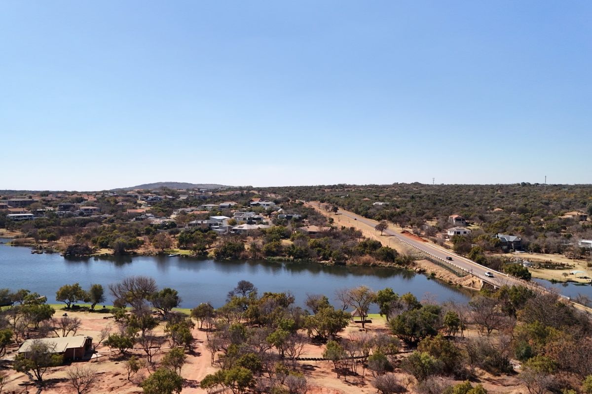 An aerial view of the commercial vacant land showing proximity to the lake, surrounding residential area, and main road access.