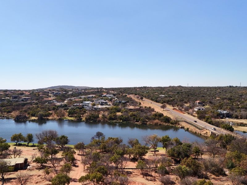 An aerial view of the commercial vacant land showing proximity to the lake, surrounding residential area, and main road access.