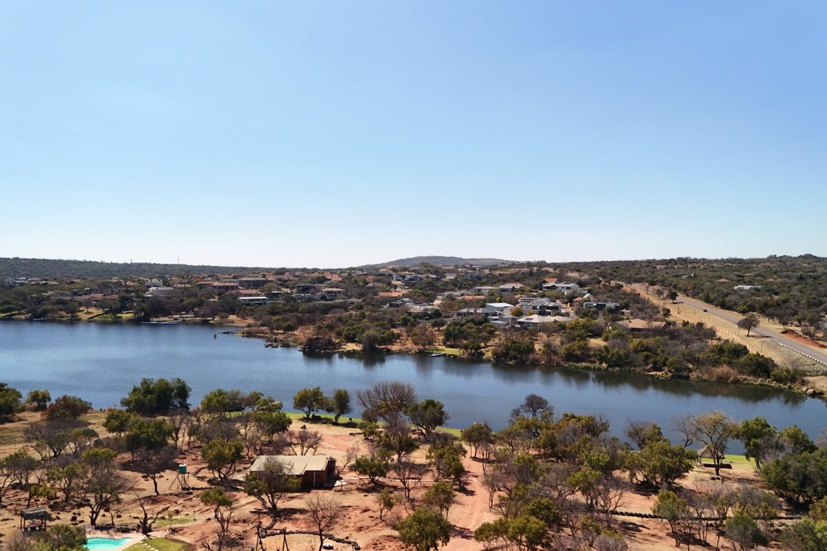 An aerial view of the vacant land property showcasing its proximity to the lake and surrounding natural landscape.