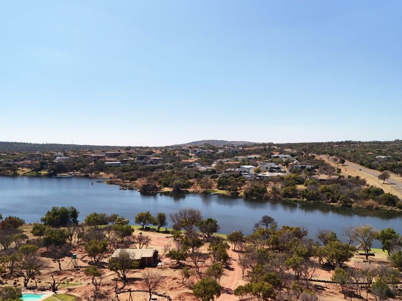 An aerial view of the vacant land property showcasing its proximity to the lake and surrounding natural landscape.