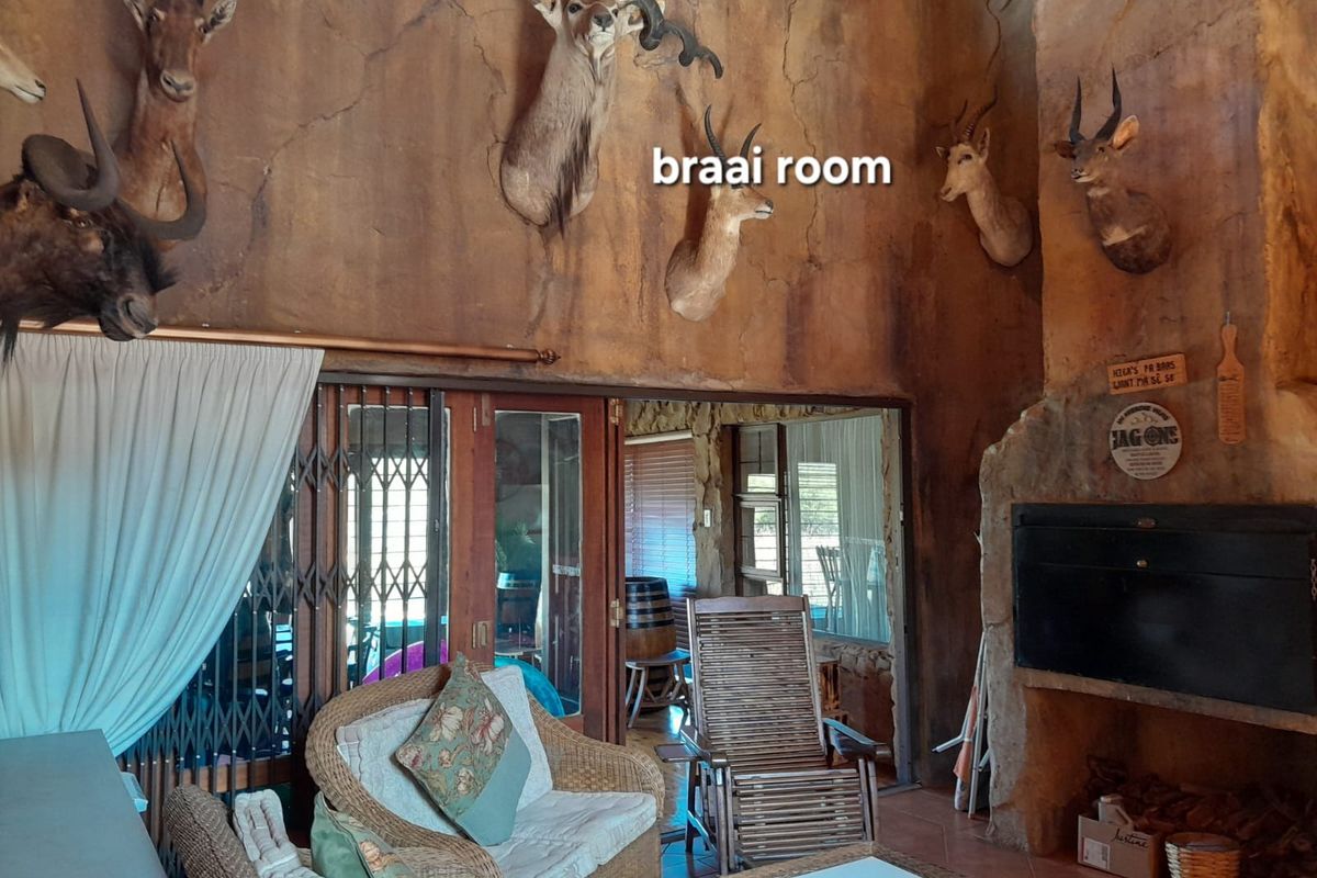 Rustic entertainment area featuring a built-in fireplace, textured wall finishes, and sliding doors leading to an adjacent space.
