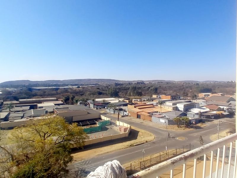 Elevated view from a balcony overlooking the surrounding neighbourhood and industrial area.