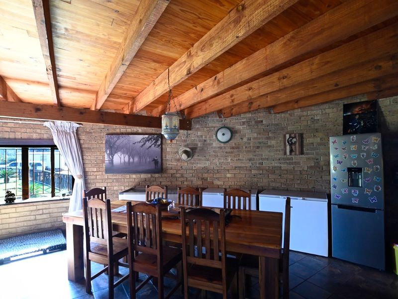 Dining area featuring rustic face brick walls and an exposed timber beam ceiling, creating a warm and traditional atmosphere.