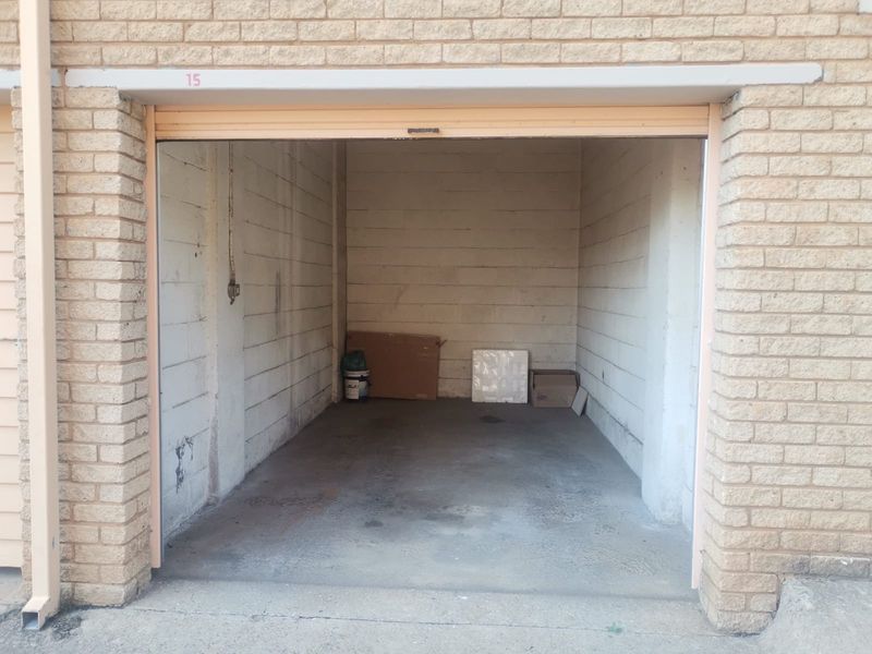 A single lock-up garage unit featuring exposed brick walls and a concrete floor, providing secure parking or storage space.