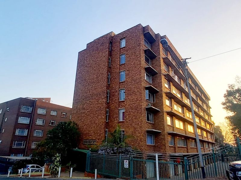 Exterior view of the Bergzicht apartment building featuring a classic face brick facade and multiple levels with private balconies.