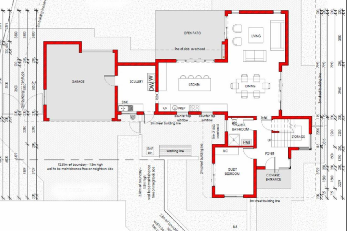 A detailed ground floor architectural plan showing the layout of the garage, kitchen, living areas, guest bedroom, and entrance.