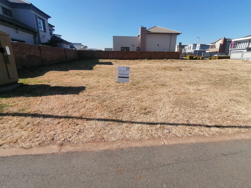 A vacant residential plot of land featuring perimeter brick walling and direct street access, ready for new development.