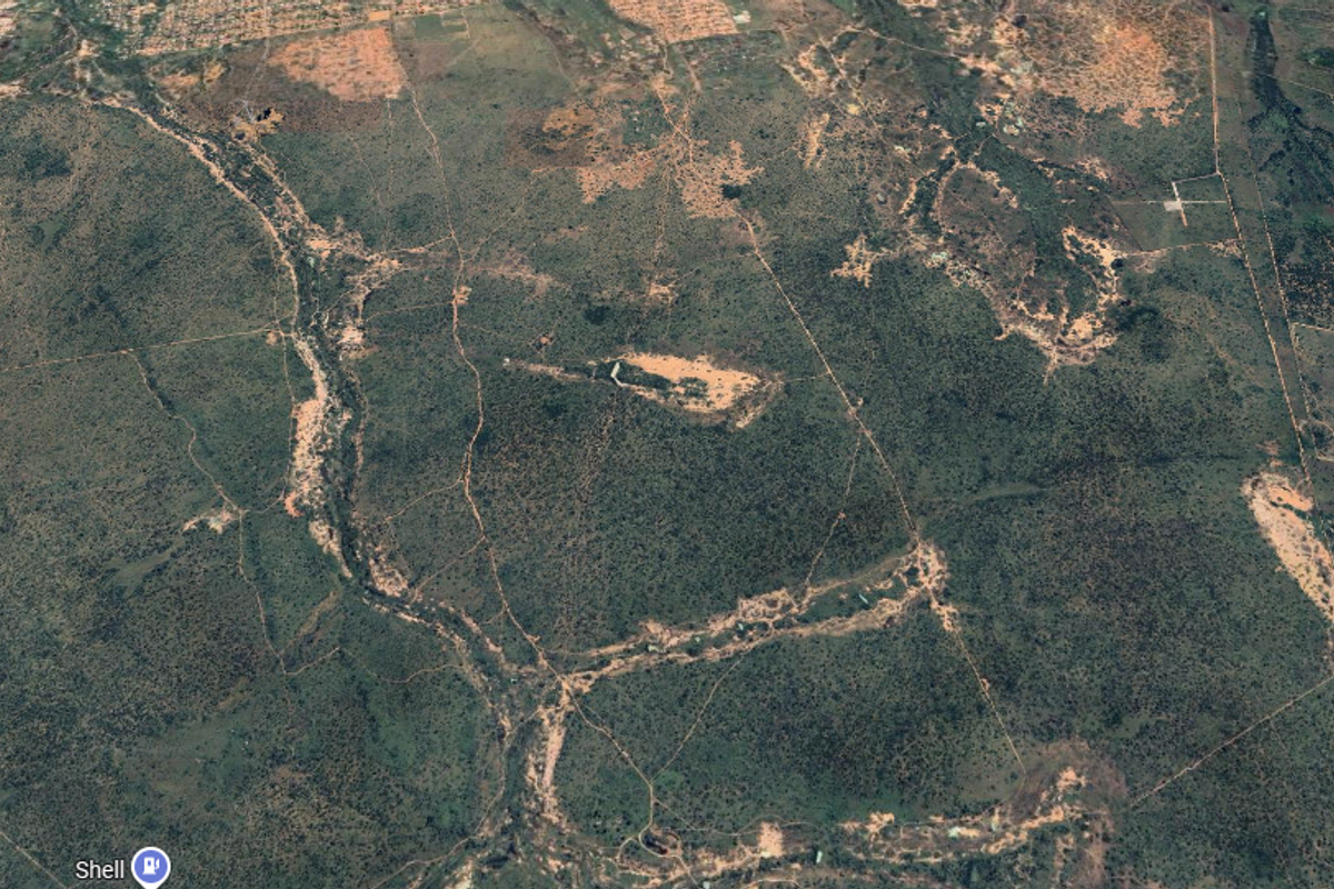 An expansive aerial view of the farm property, showcasing the vast landscape, natural terrain, and surrounding rural environment.
