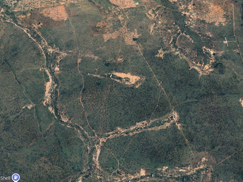 An expansive aerial view of the farm property, showcasing the vast landscape, natural terrain, and surrounding rural environment.
