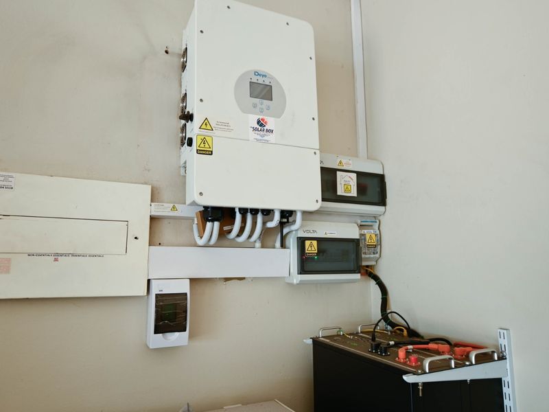 A utility area featuring a Deye solar inverter, electrical distribution board, and a lithium battery bank for off-grid power storage.