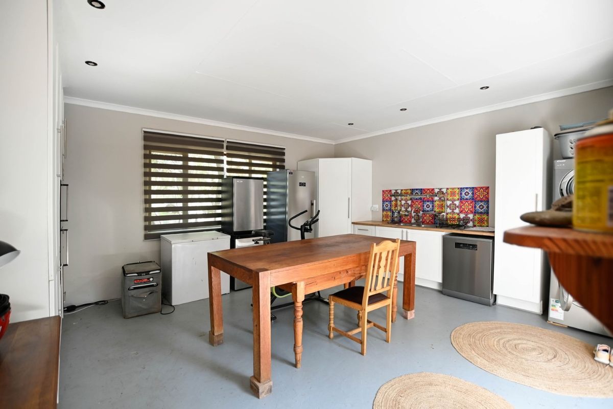 A functional kitchen area featuring built-in cabinetry, a decorative tile backsplash, and recessed lighting, offering a practical space for meal preparation.
