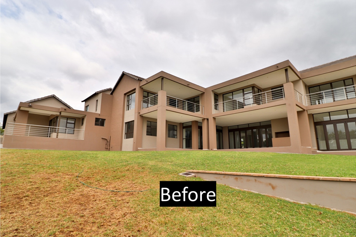 Rear view of a multi-level residential property featuring extensive balconies with stainless steel balustrades, large glass doors, and a landscaped garden area.