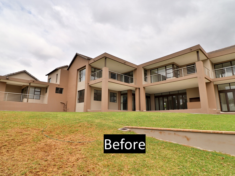 Rear view of a multi-level residential property featuring extensive balconies with stainless steel balustrades, large glass doors, and a landscaped garden area.