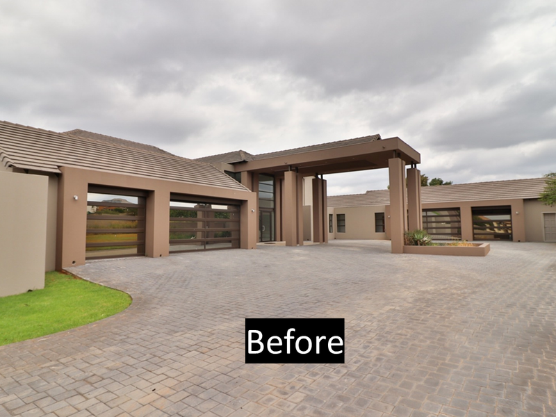 Modern architectural front elevation featuring a spacious paved driveway, triple garage, and a prominent covered porte-cochere entrance.