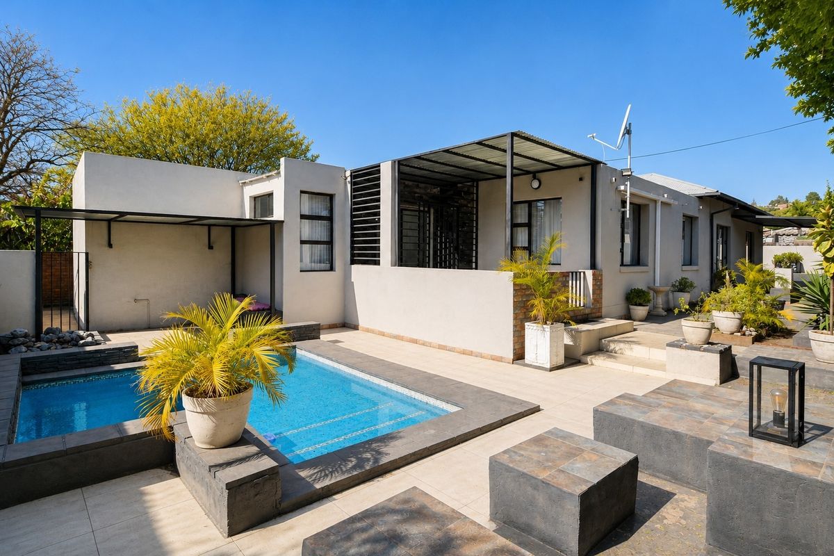 Rear exterior view featuring a swimming pool, tiled patio area, and covered outdoor space with modern architectural lines.