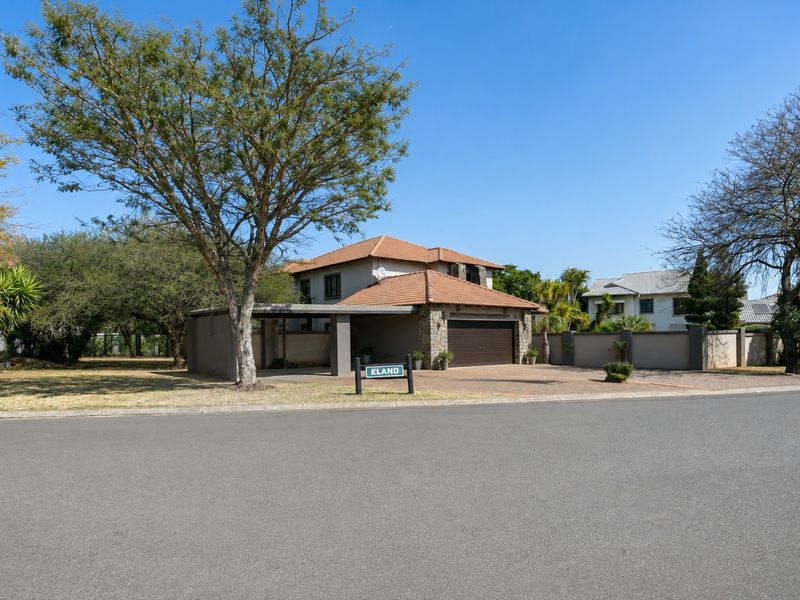 Front exterior view of a double-story house featuring a tiled roof, paved driveway, and integrated garage.