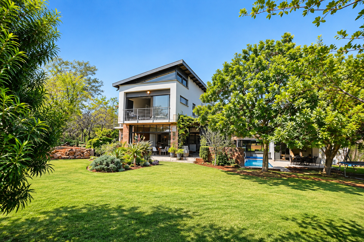 A well-maintained rear elevation featuring a modern multi-story design, a swimming pool, a spacious balcony, and a lush landscaped garden.