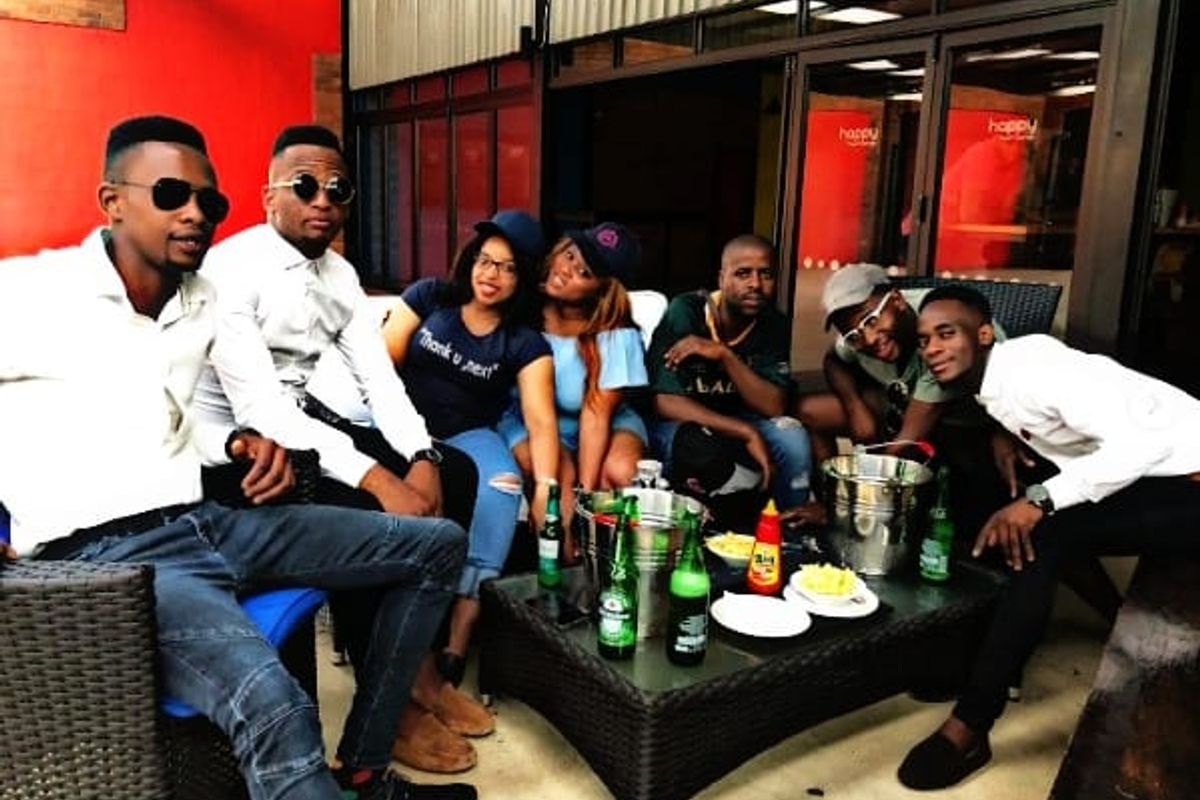 A covered outdoor patio area featuring a concrete floor and metal roofing, suitable for social gatherings and entertainment.