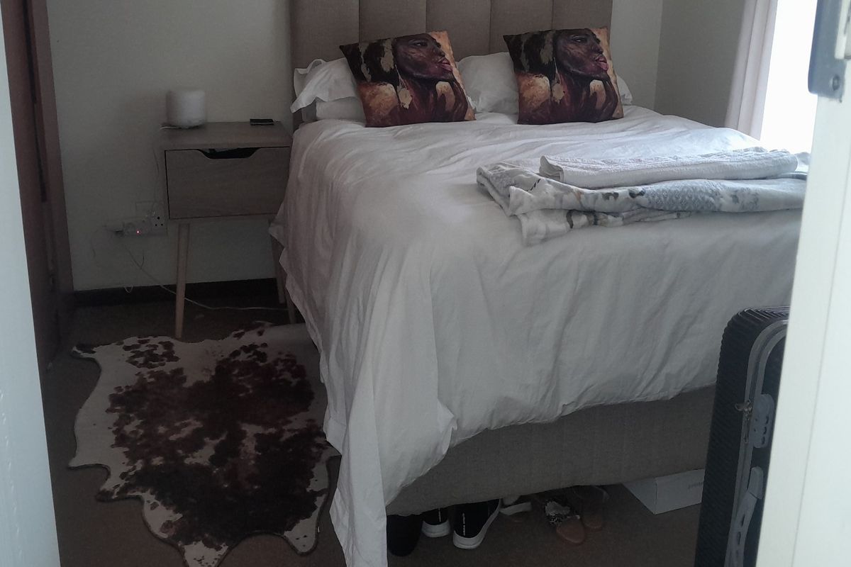 A bedroom featuring neutral carpeting and a standard layout, providing a functional space for rest.