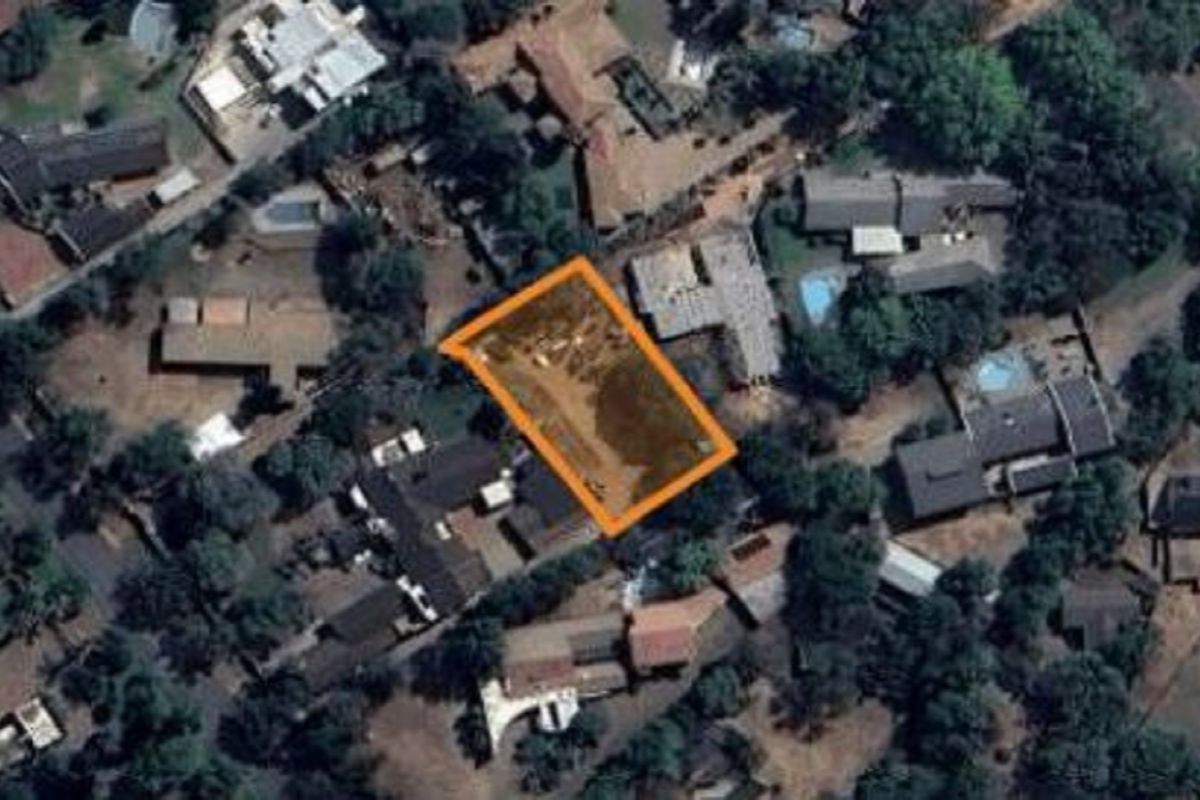 Aerial view of a vacant residential plot highlighted in an established suburban neighborhood.