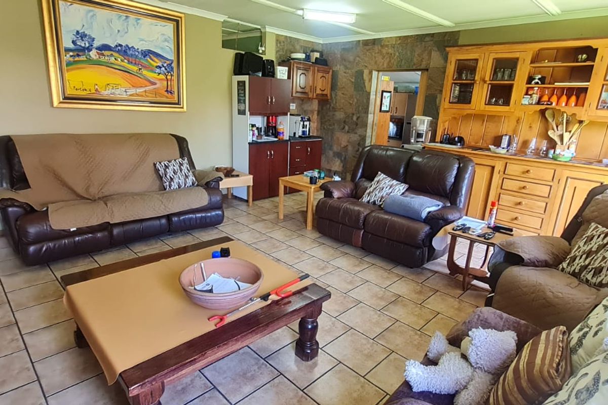 Spacious living area featuring tiled flooring and a stone-clad feature wall, providing a comfortable and functional space for relaxation.