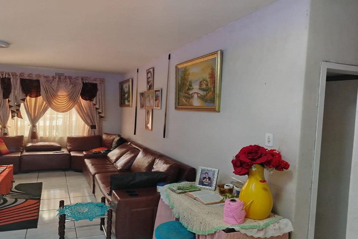 A living room area featuring tiled flooring and neutral wall finishes, providing a functional space for relaxation.
