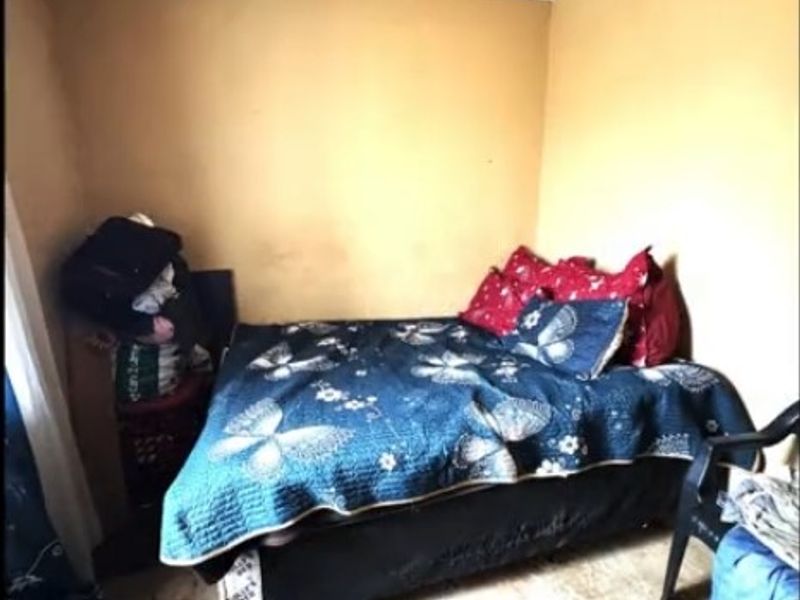 A compact bedroom featuring plain walls and coving, currently requiring cosmetic updates to the wall finishes and flooring to improve its overall condition.