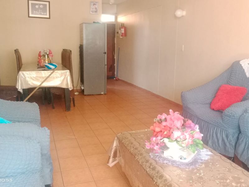 Open plan living and dining area featuring tiled flooring and neutral wall finishes.