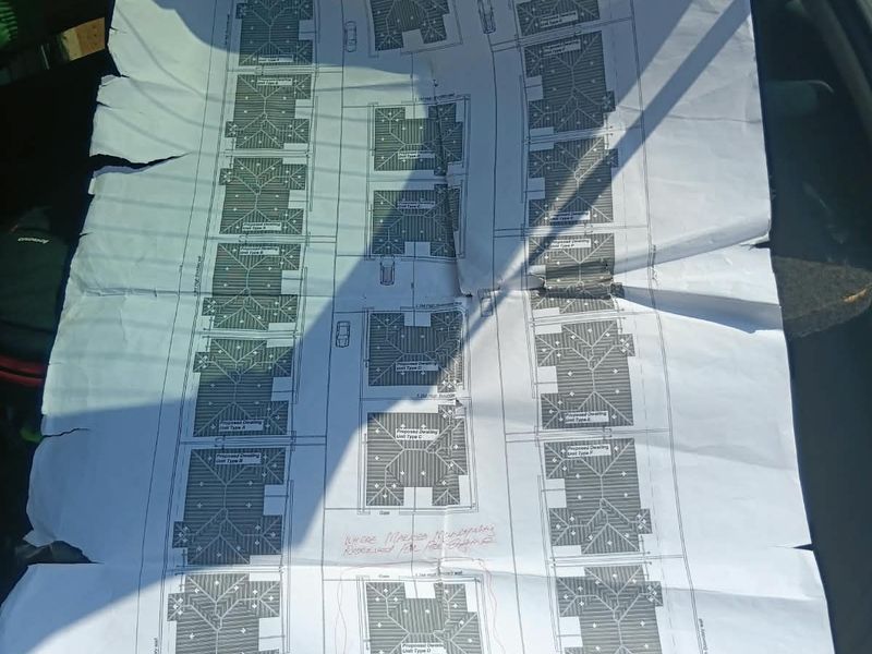 A printed site layout plan showing the proposed residential development and unit positioning on the land.