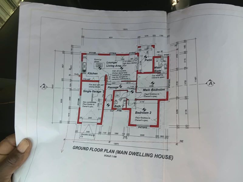 A detailed ground floor plan for a residential dwelling featuring a single garage, two bedrooms, two bathrooms, and an open-plan kitchen and living area.