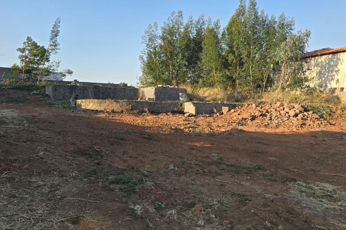 Vacant residential land featuring an existing brick foundation and perimeter walling, offering a cleared site ready for development.