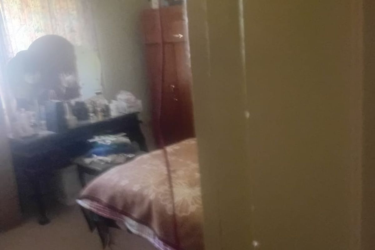 A view into a bedroom featuring a ceiling fan, captured from the doorway.