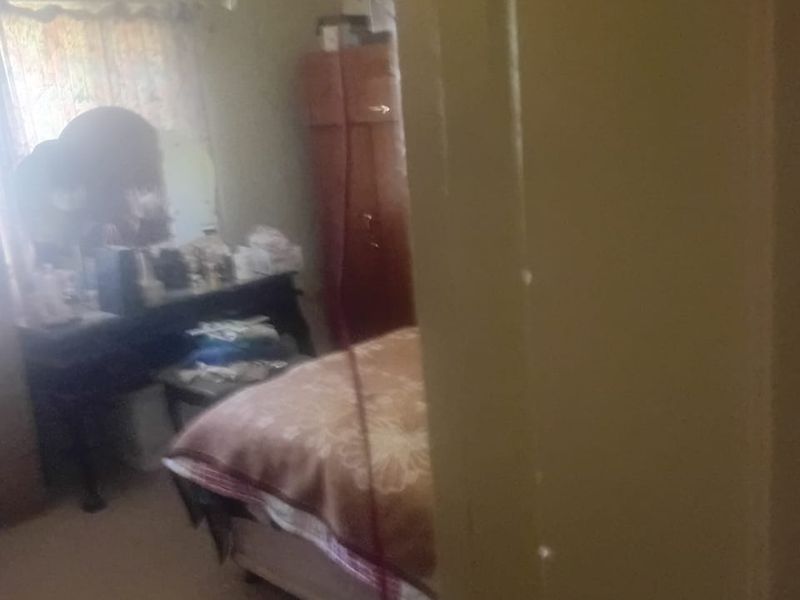 A view into a bedroom featuring a ceiling fan, captured from the doorway.