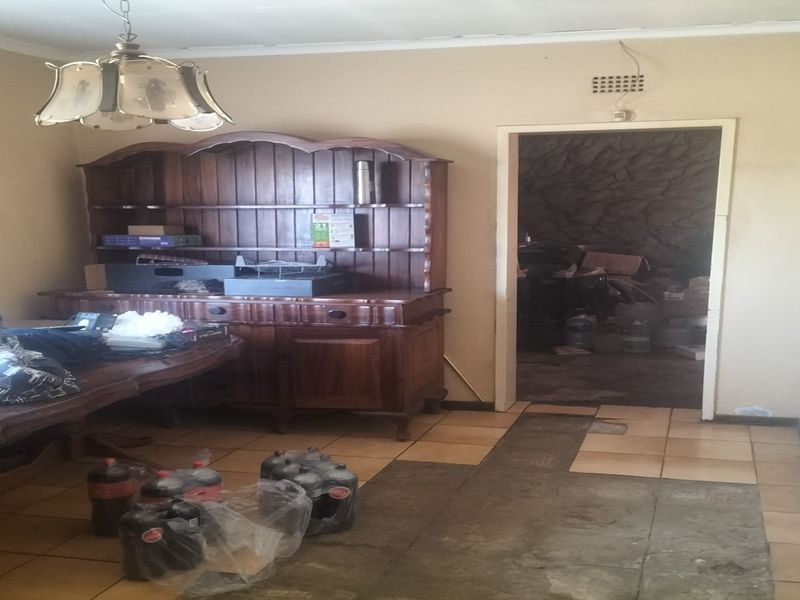 Dining room area featuring ceramic floor tiles, a ceiling light fixture, and a doorway leading to an adjacent space.