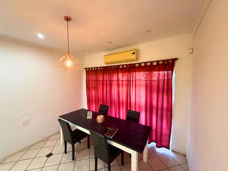 Dining room featuring tiled flooring, a modern pendant light fixture, and a wall-mounted split-system air conditioner.