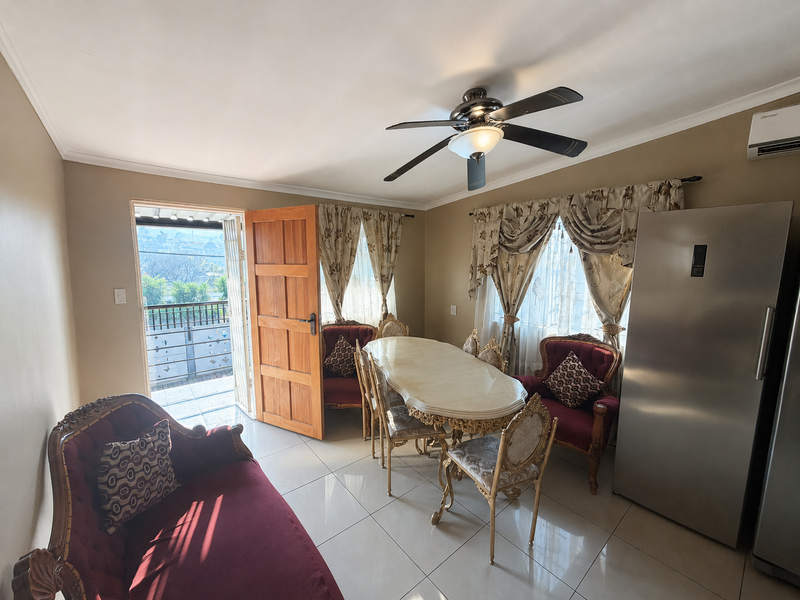 Dining area featuring tiled flooring, a ceiling fan, and direct access to an outdoor balcony space.
