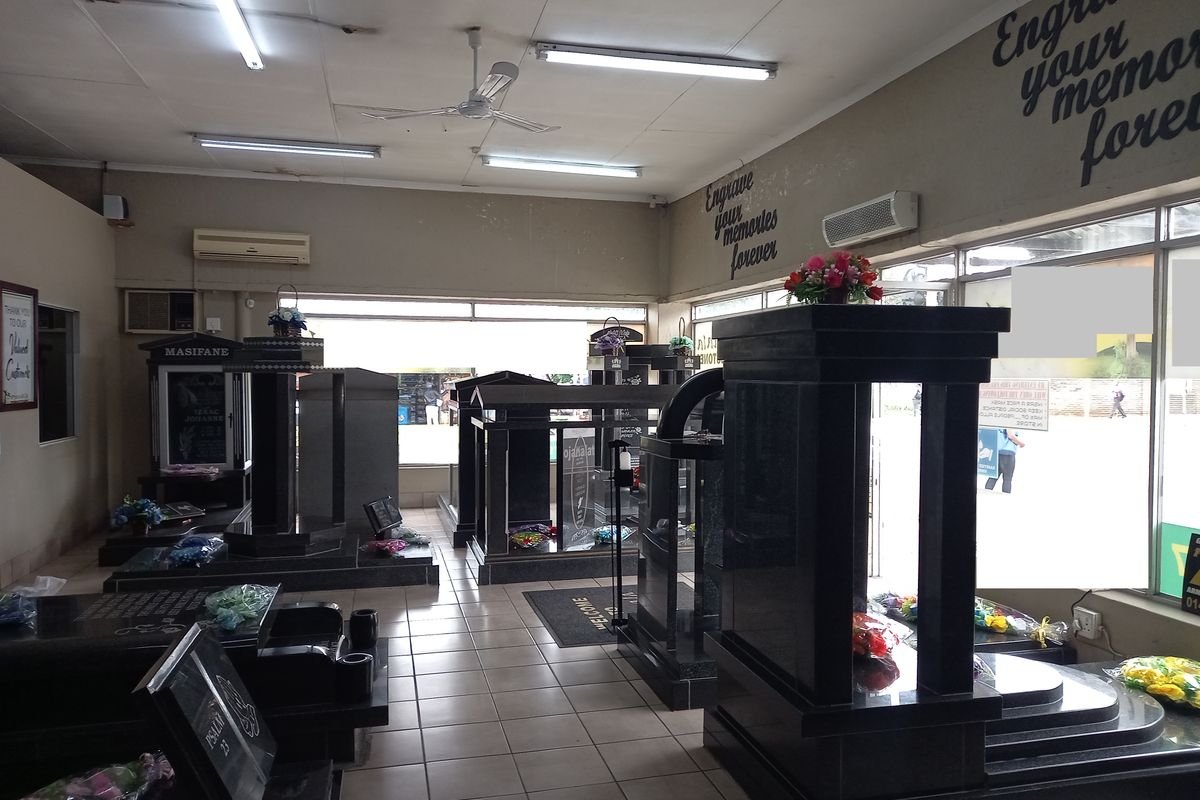Retail showroom space featuring tiled flooring, large display windows, and multiple split-system air conditioning units.