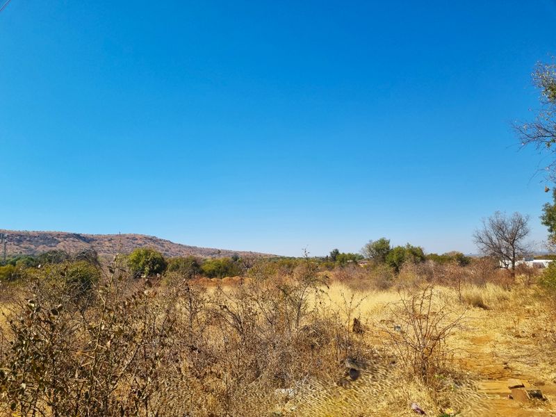 A scenic view of the natural landscape and surrounding hills on this vacant residential property.