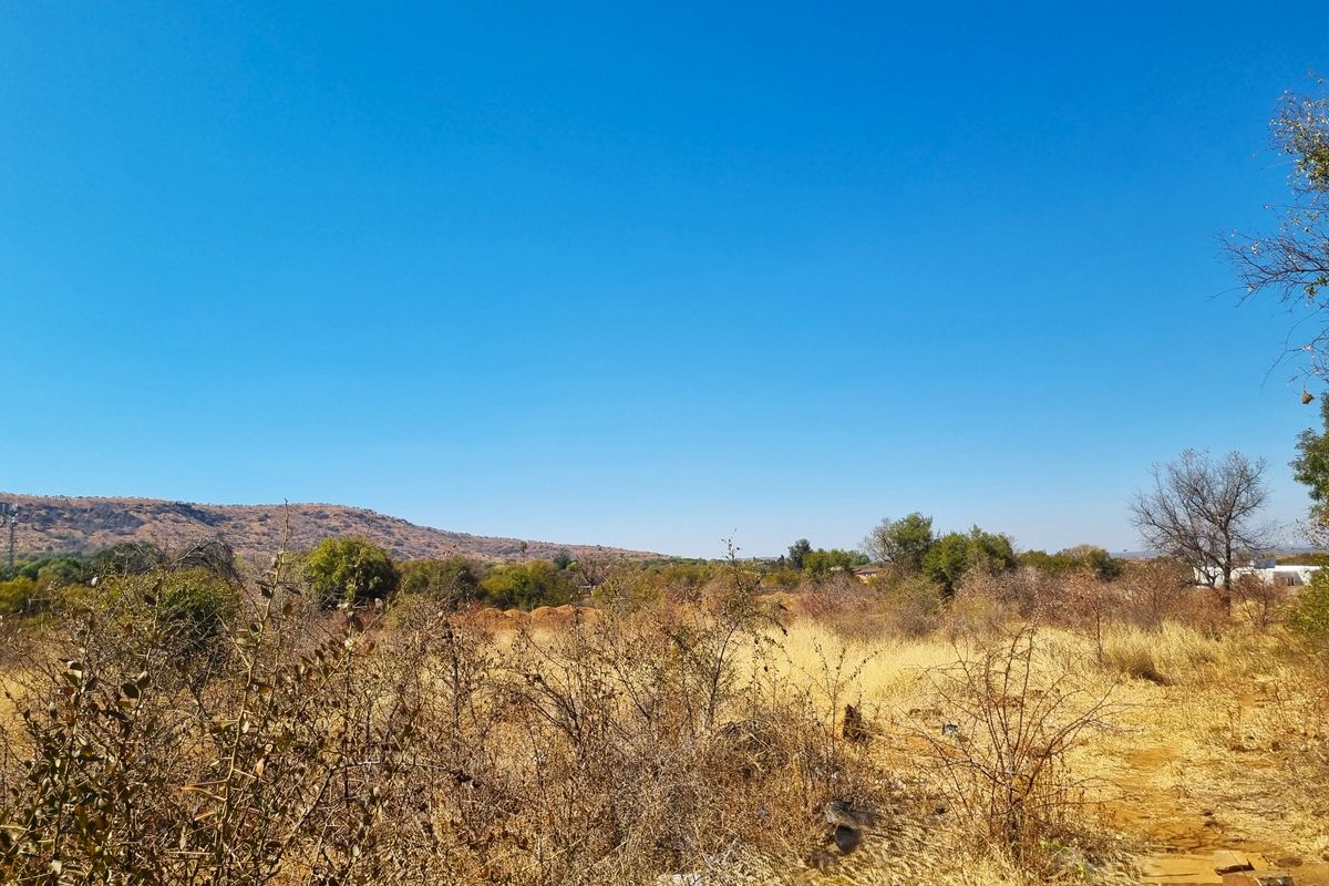 A scenic view of the natural landscape and surrounding hills on this vacant residential property.
