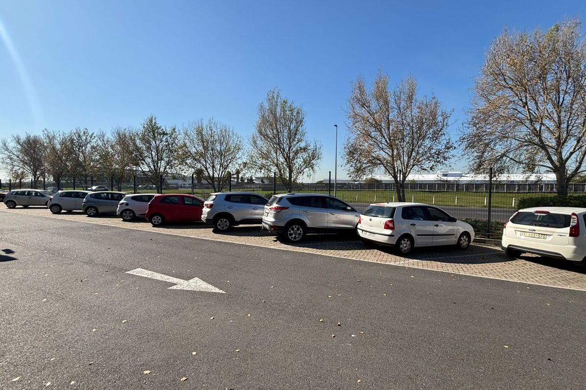 An outdoor parking area featuring paved bays and perimeter fencing, providing convenient vehicle access for the industrial property.