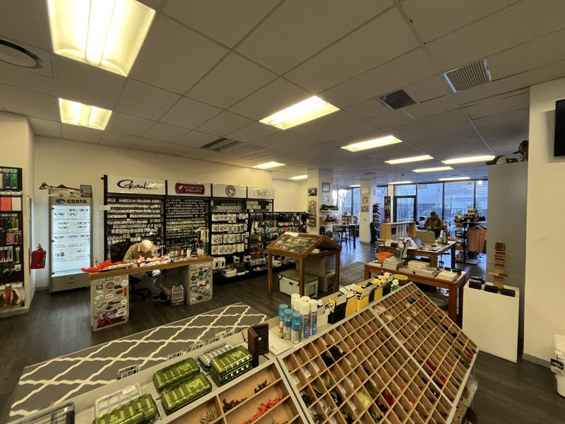 Spacious commercial office or retail space featuring a suspended ceiling, recessed lighting, and large glass windows providing ample natural light.