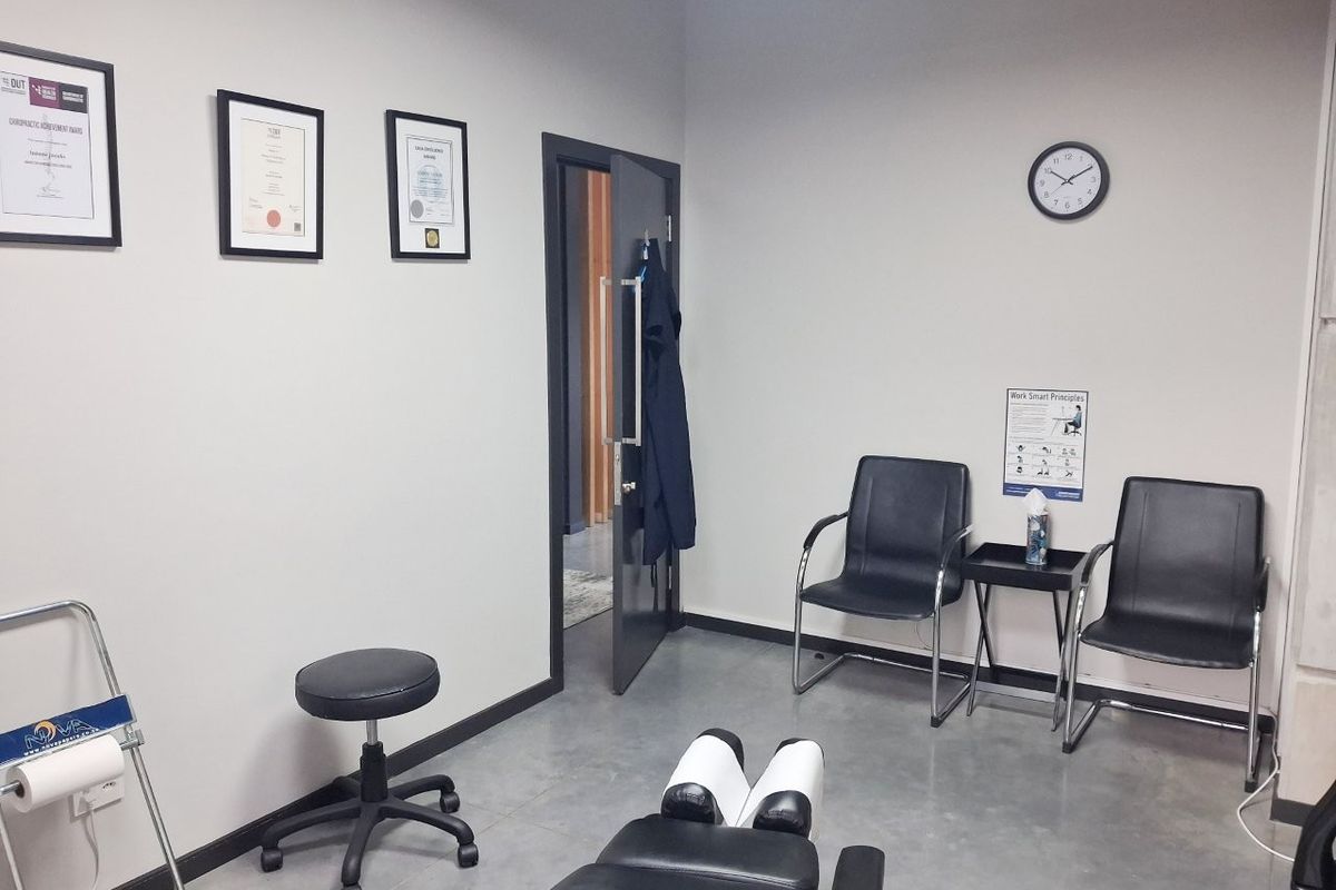 A functional commercial office or treatment room featuring polished concrete floors and a clean, professional layout suitable for clinical or administrative use.