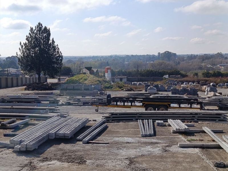 Expansive industrial yard space featuring concrete paving, perimeter walling, and open storage area suitable for various commercial or industrial operations.