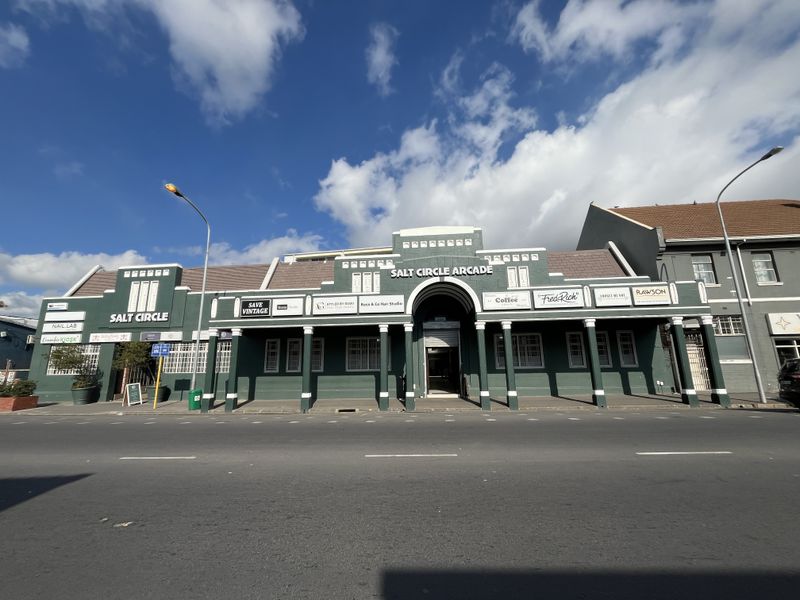 Front elevation of Salt Circle Arcade, a well-maintained commercial building featuring a covered walkway, multiple storefronts, and classic architectural detailing.