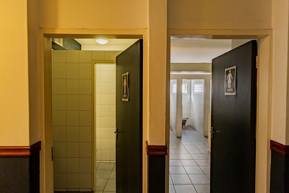Commercial restroom facility featuring separate Gents and Ladies entrances with tiled flooring and wall finishes.