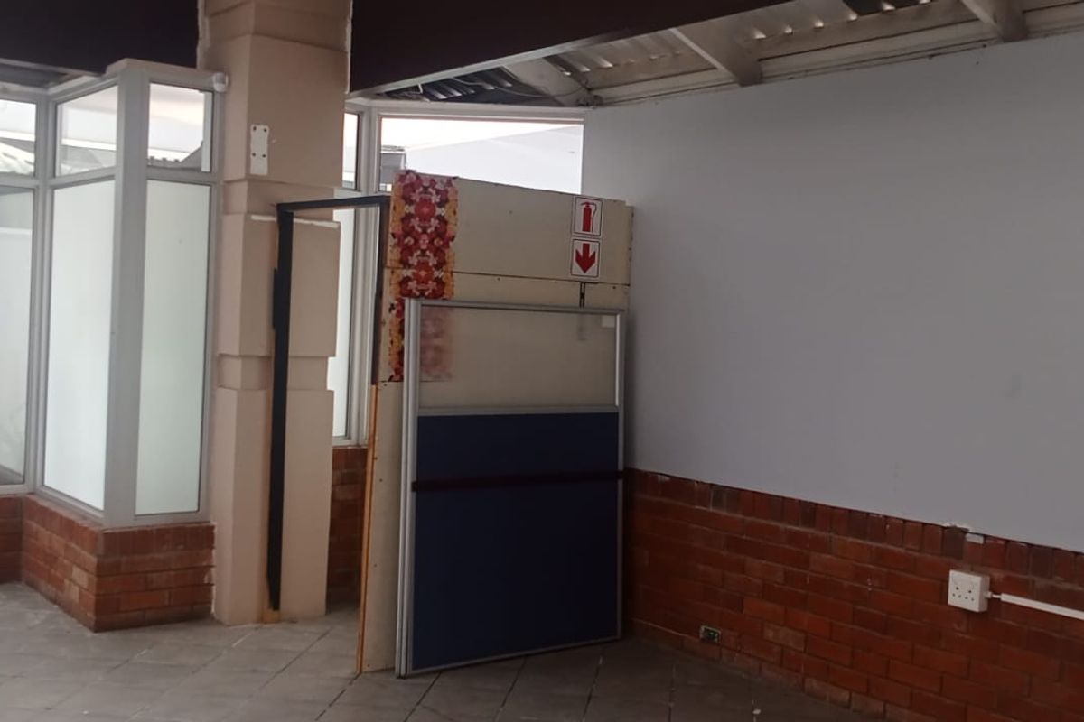 An open-plan retail space featuring exposed brickwork, aluminium window frames, and unfinished ceiling elements, offering a blank canvas for custom commercial fit-out.