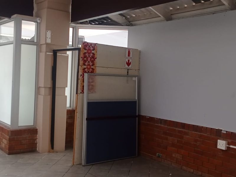 An open-plan retail space featuring exposed brickwork, aluminium window frames, and unfinished ceiling elements, offering a blank canvas for custom commercial fit-out.
