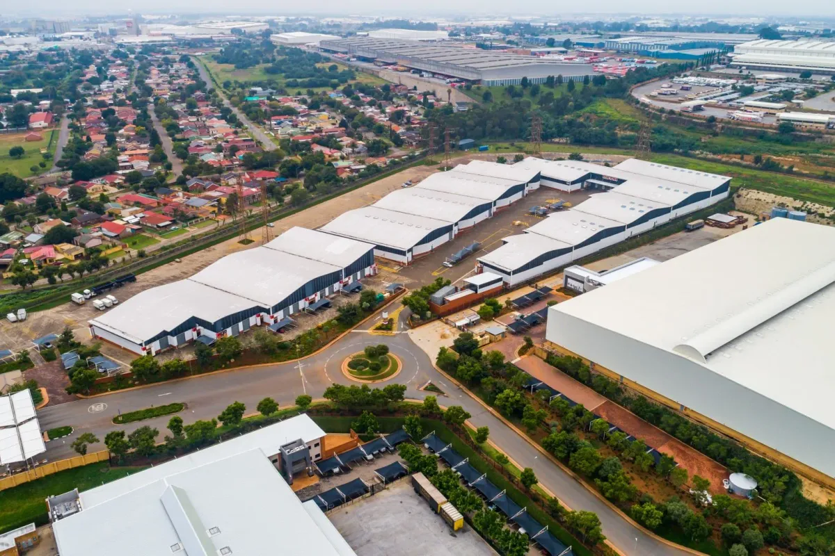 Aerial view of a large-scale industrial warehouse complex featuring multiple units, extensive loading areas, and integrated road infrastructure within a business park setting.